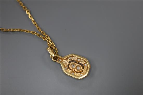 A modern yellow metal (stamped 750) and diamond set pendant, 13mm, on an unmarked yellow metal chain, gross 5.5 grams.